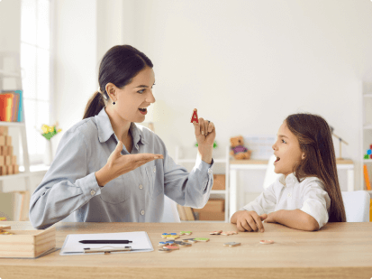 speech pathologist holding up letter